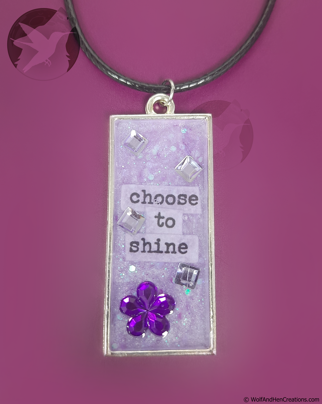 Necklace with a pendant that says 'choose to shine' on a purple background