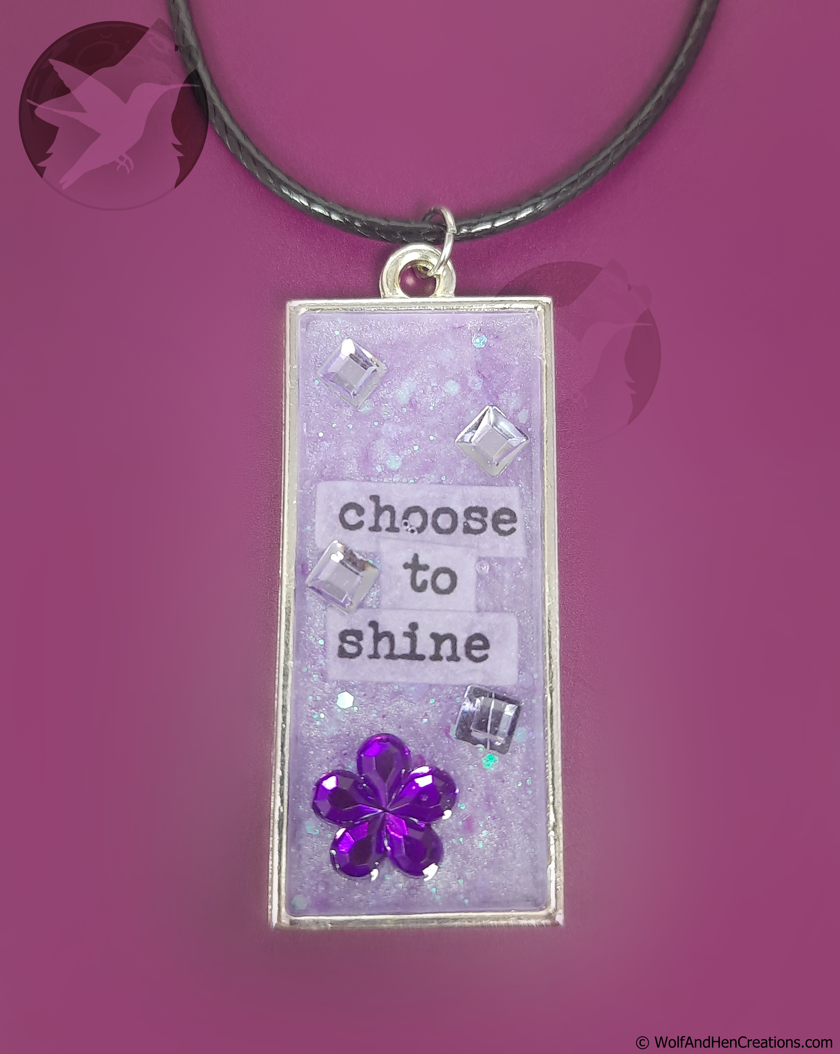 Necklace with a pendant that says 'choose to shine' on a purple background