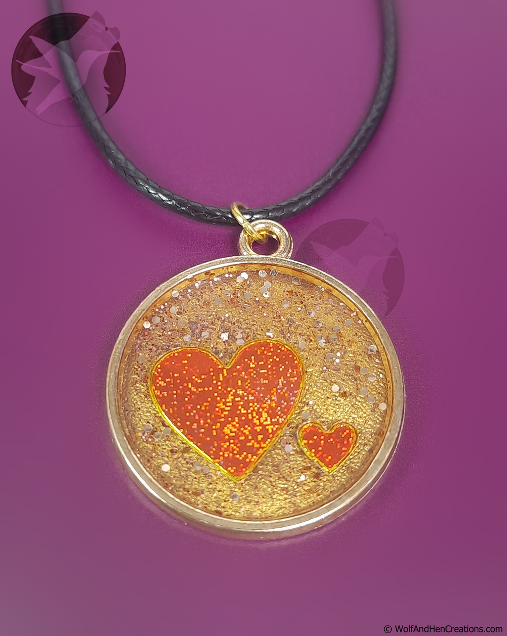 Necklace with a round pendant featuring a red heart design on a purple background