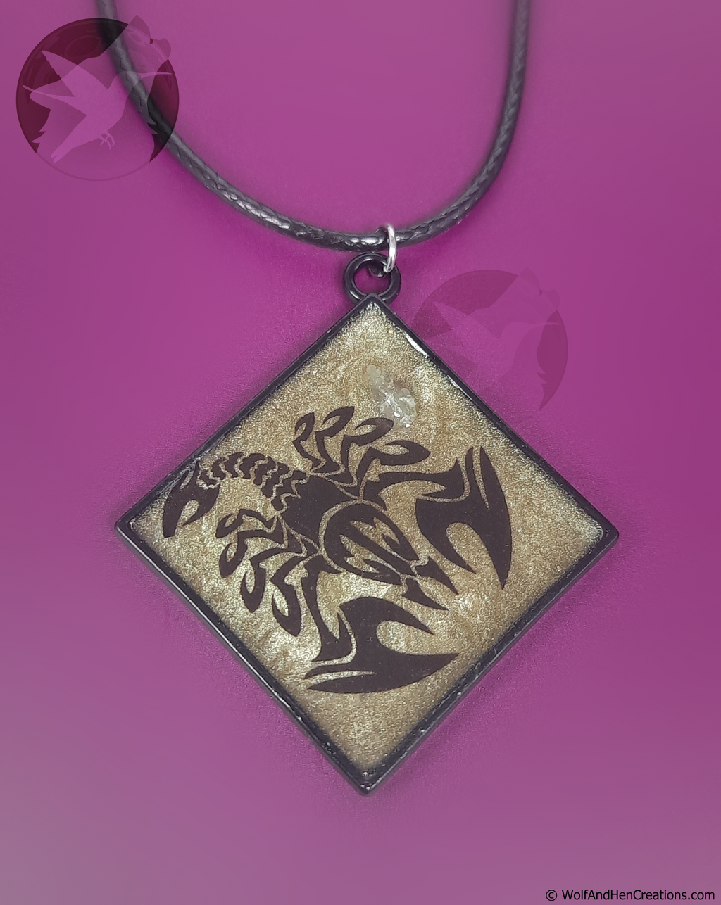 Square pendant with dragon design on a purple background