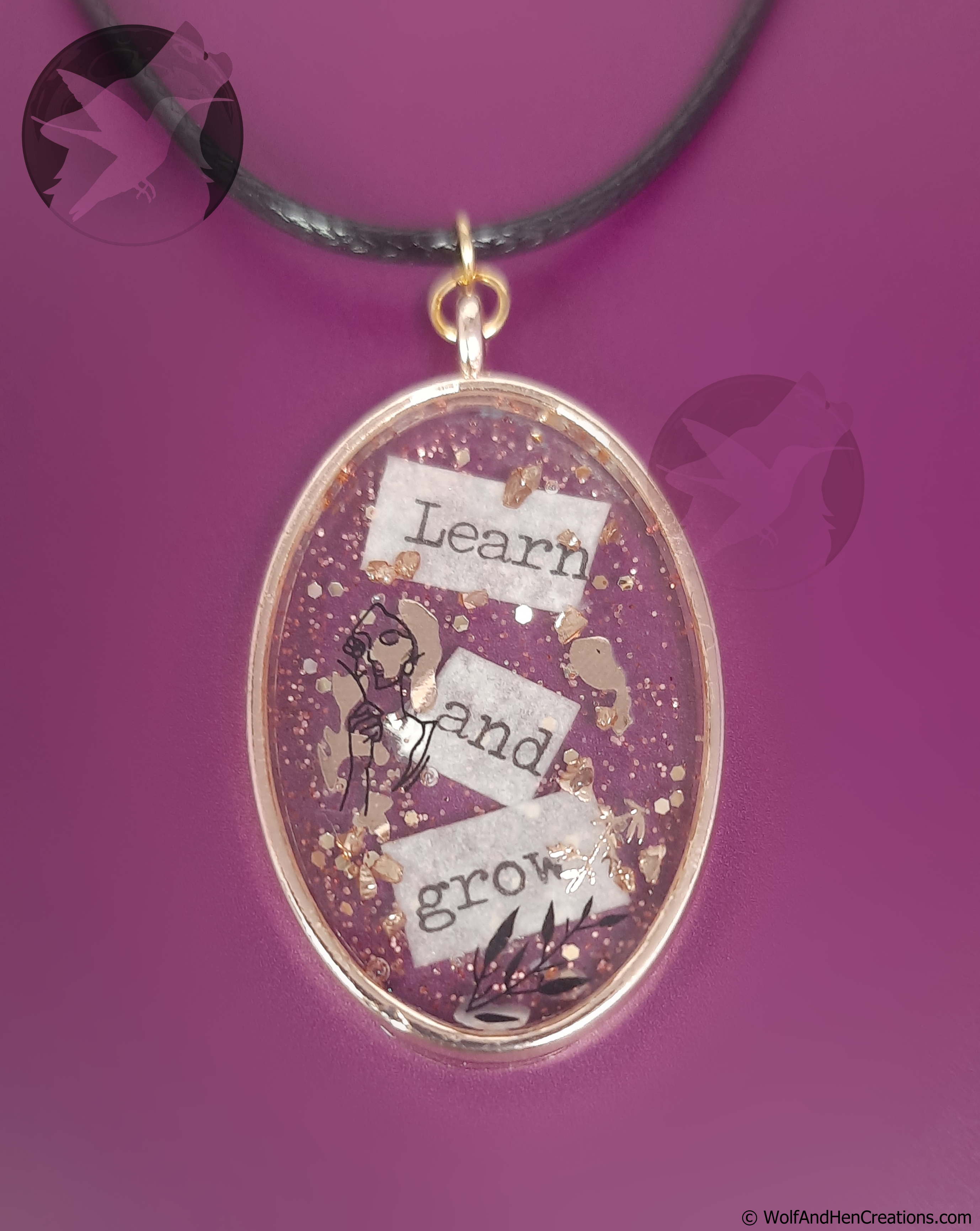Oval-shaped pendant with motivational text on a purple background