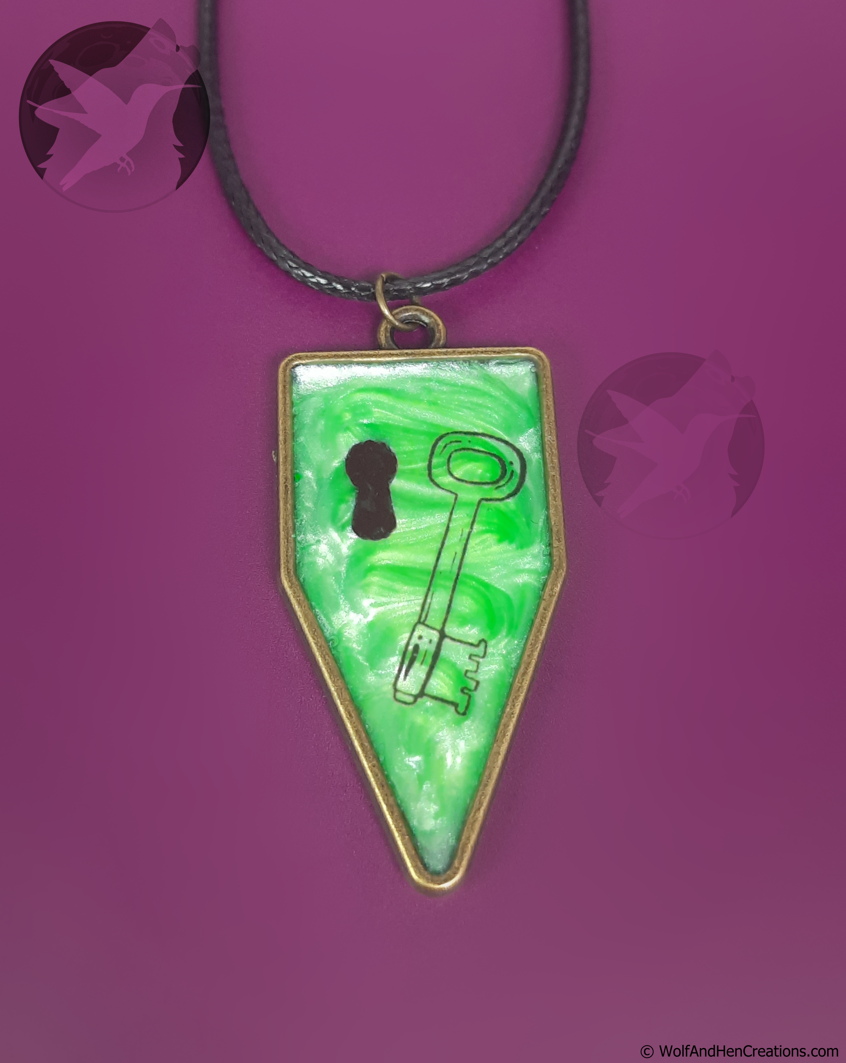 Necklace with a green pendant featuring a key design on a purple background