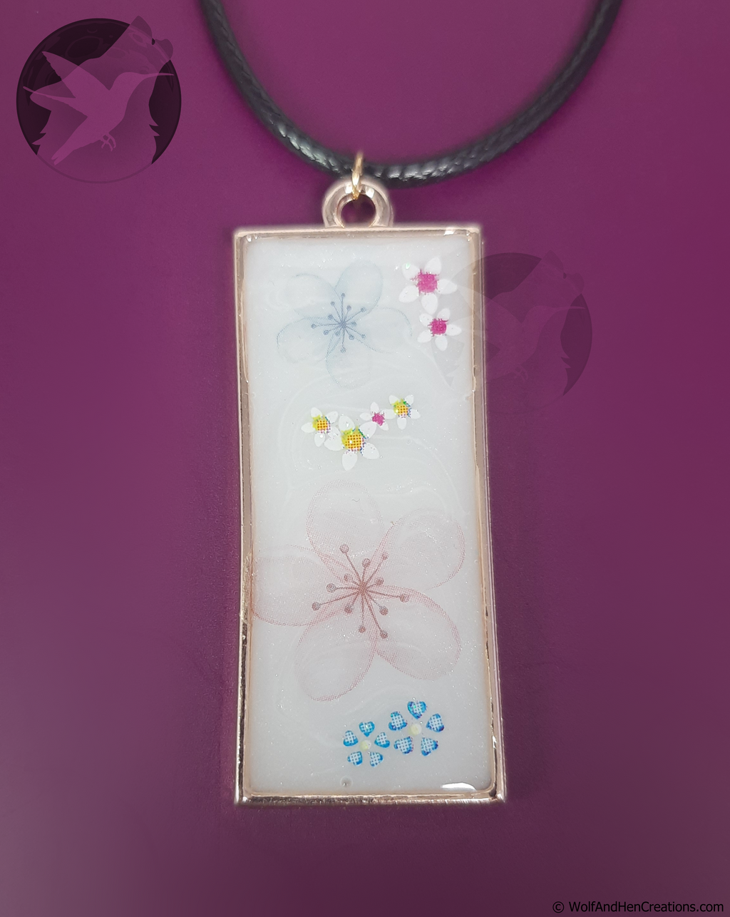 Rectangular pendant with floral designs on a purple background