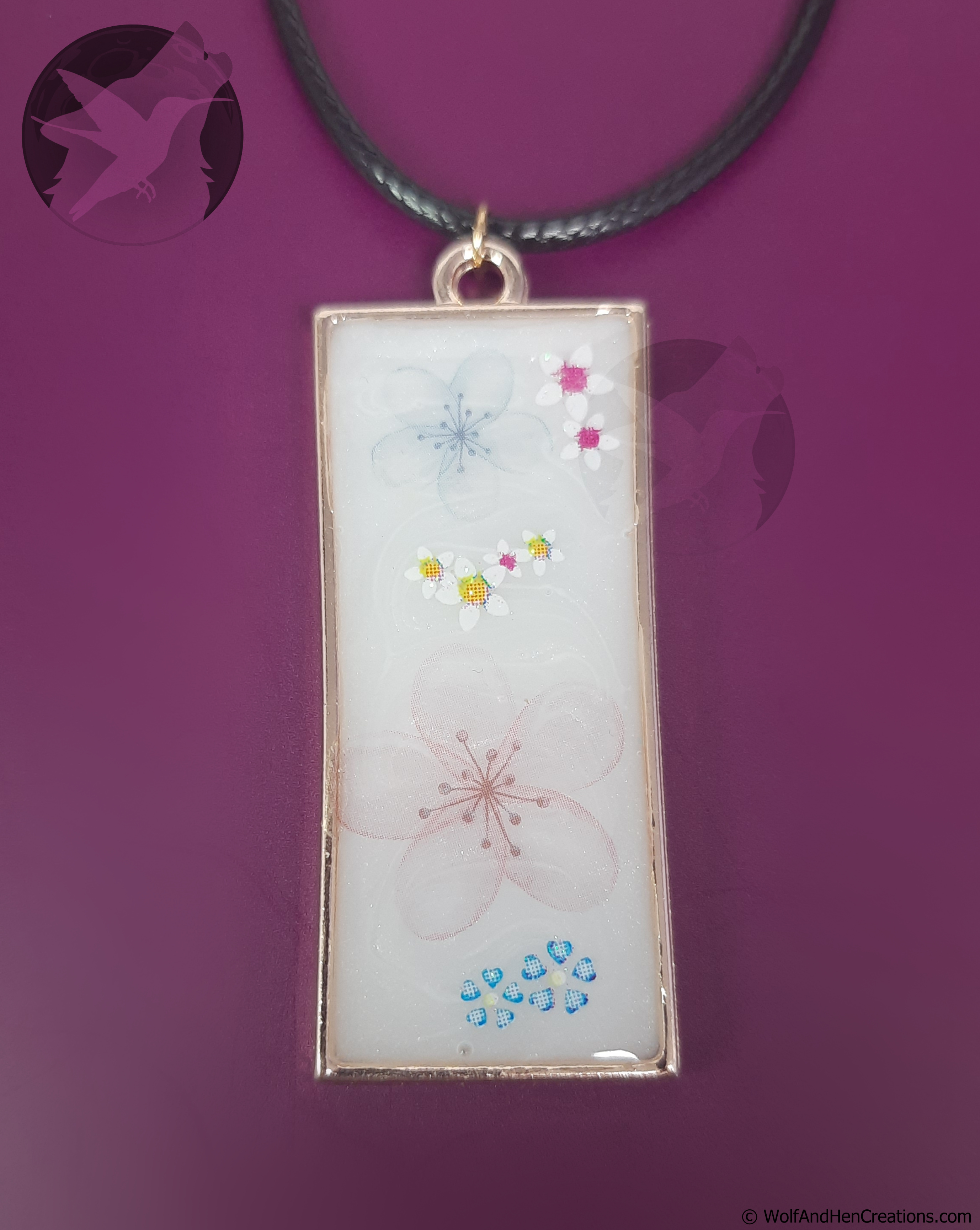Rectangular pendant with floral designs on a purple background